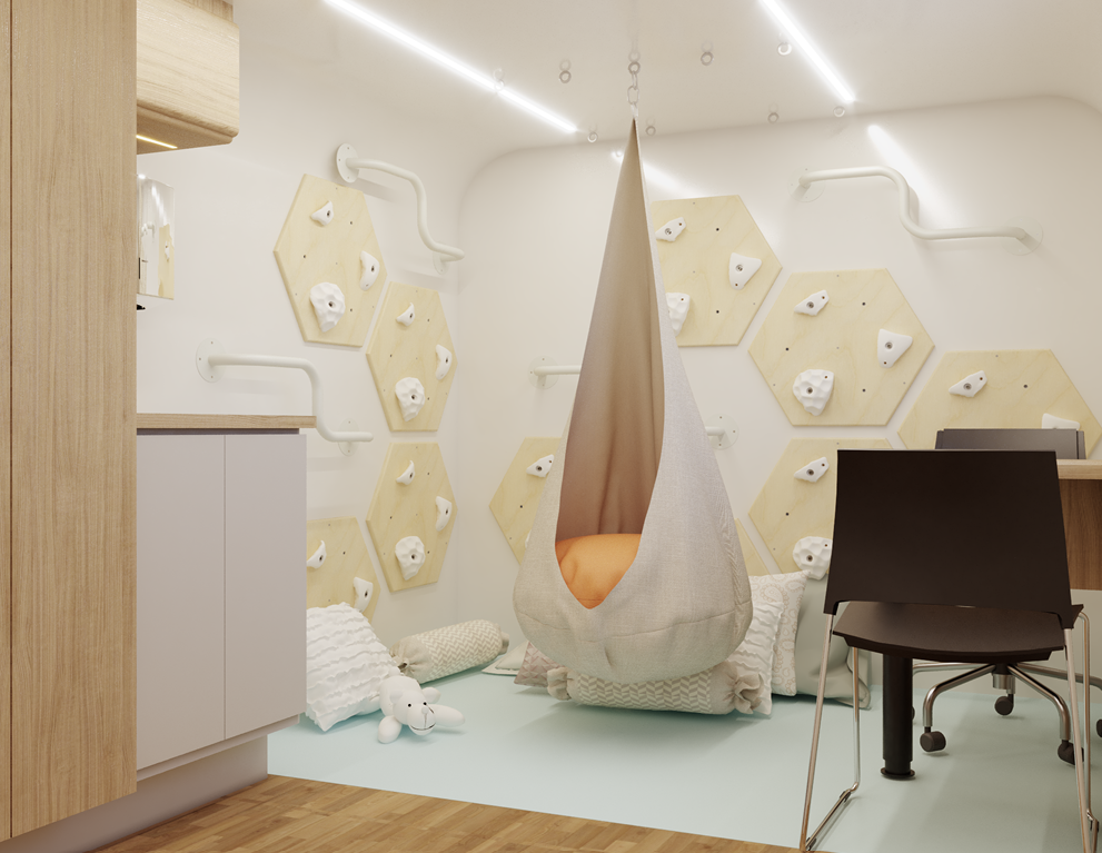 Sala com painéis de escalada, balanço e área de acolhimento